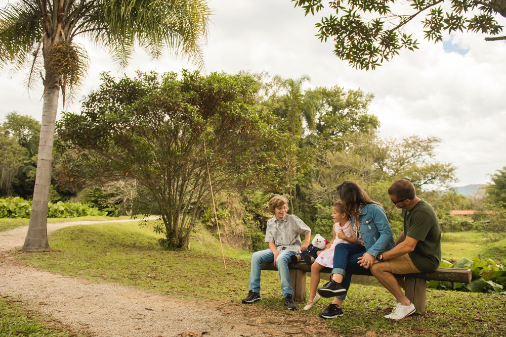 Família sentada em um banco na natureza